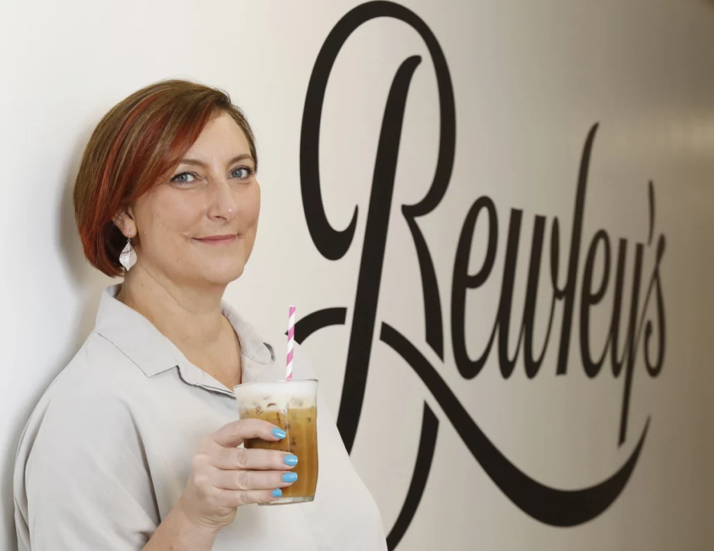 Julie Murray with chilled coffee in front of Bewleys signage